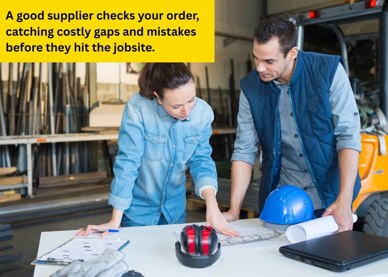 Two construction professionals reviewing blueprints and planning materials inside a workshop